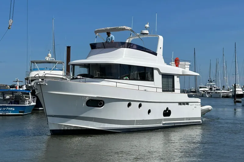 Smooth Yacht Photos Pics 2019 Beneteau Swift Trawler 50 in marina, clear sky, multiple boats in background.