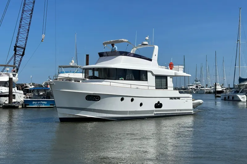 Smooth Yacht Photos Pics 2019 Beneteau Swift Trawler 50 docked in a marina, surrounded by other boats.