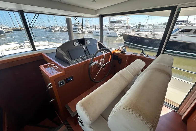 Smooth Yacht Photos Pics 2019 Beneteau Swift Trawler 50 helm station with marina view.
