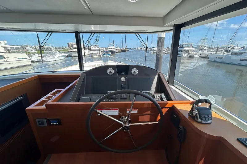 Smooth Yacht Photos Pics Helm of 2019 Beneteau Swift Trawler 50 with marina view.