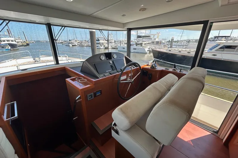 Smooth Yacht Photos Pics 2019 Beneteau Swift Trawler 50 helm station with marina view.