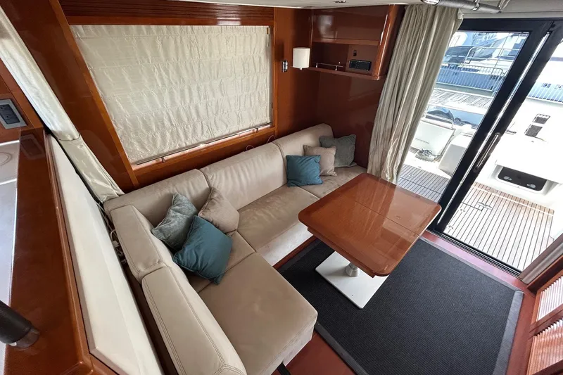 Smooth Yacht Photos Pics Luxurious interior of 2019 Beneteau Swift Trawler 50 with cozy seating and elegant table.