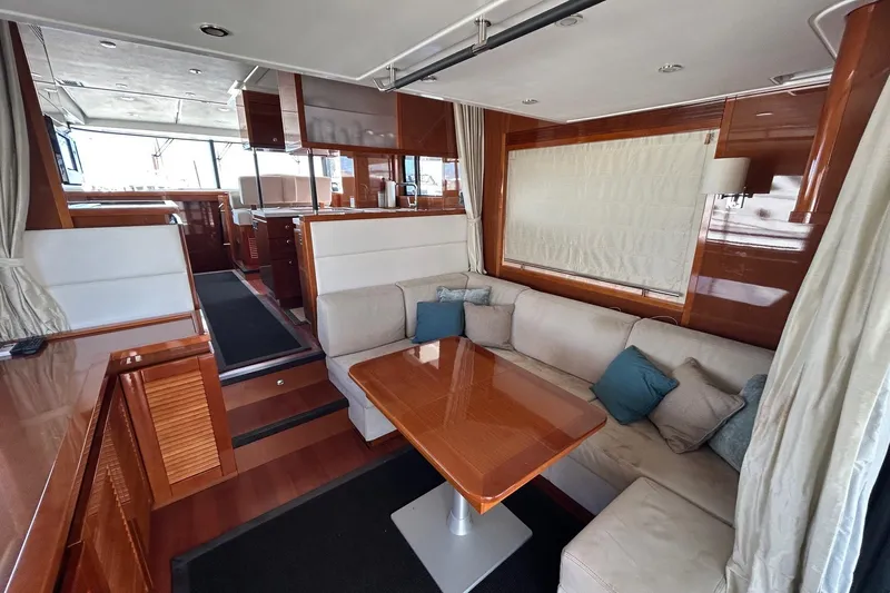 Smooth Yacht Photos Pics Luxurious interior of 2019 Beneteau Swift Trawler 50 with elegant seating and wooden finishes.