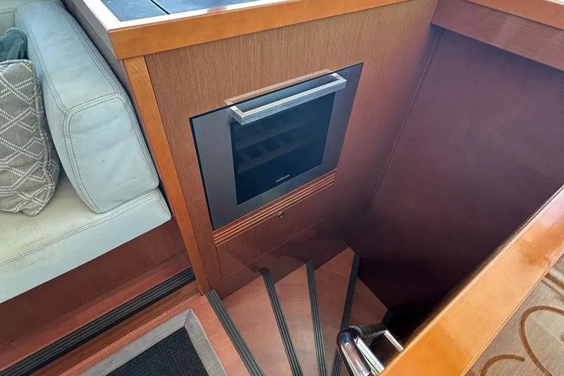 Smooth Yacht Photos Pics Interior of 2019 Beneteau Swift Trawler 50 with stairs and built-in appliance.