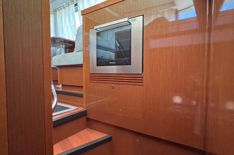 Smooth Yacht Photos Pics Interior of 2019 Beneteau Swift Trawler 50 with modern wood finish and built-in oven.