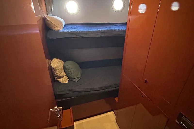 Smooth Yacht Photos Pics 2019 Beneteau Swift Trawler 50 cabin with bunk beds and porthole window.