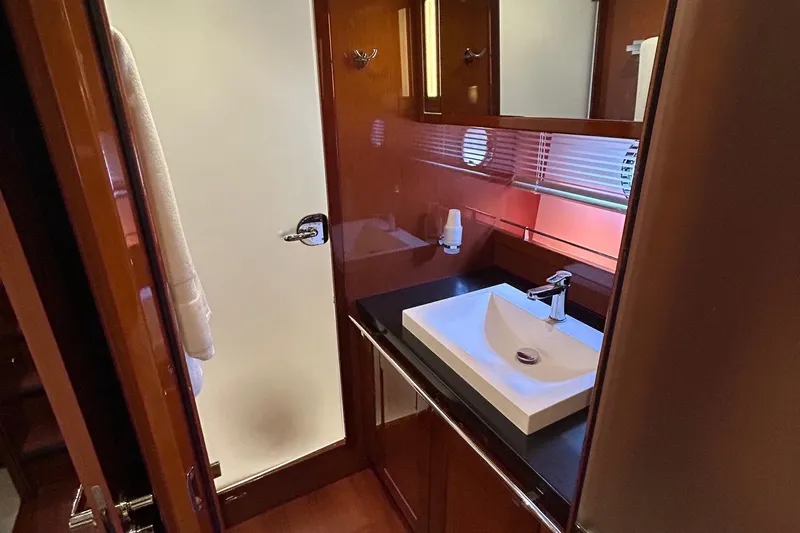 Smooth Yacht Photos Pics Bathroom interior of 2019 Beneteau Swift Trawler 50 with modern sink and wooden cabinetry.