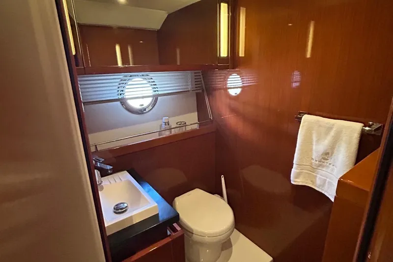 Smooth Yacht Photos Pics Luxurious bathroom in 2019 Beneteau Swift Trawler 50 with modern fixtures and porthole window.