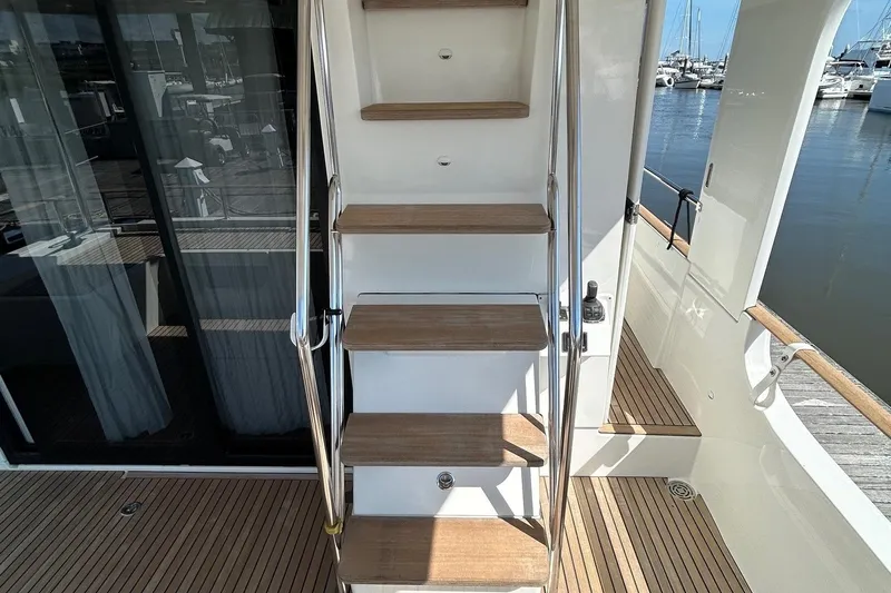Smooth Yacht Photos Pics Staircase on 2019 Beneteau Swift Trawler 50 yacht, leading to upper deck.
