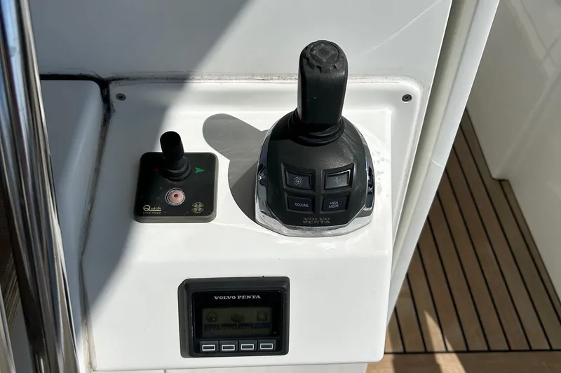 Smooth Yacht Photos Pics Control panel of a 2019 Beneteau Swift Trawler 50 with joystick and Volvo Penta display.