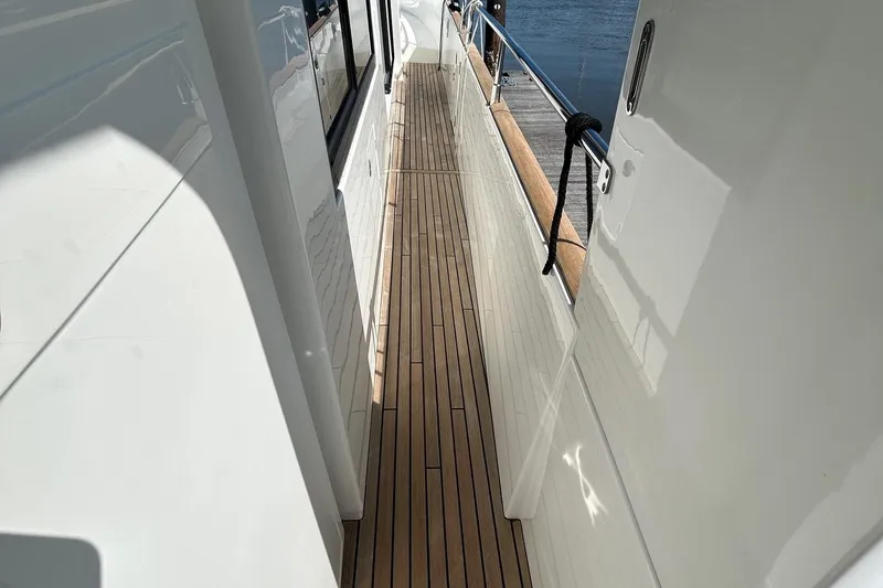 Smooth Yacht Photos Pics 2019 Beneteau Swift Trawler 50 side deck with teak flooring and stainless steel railing.