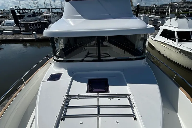 Smooth Yacht Photos Pics 2019 Beneteau Swift Trawler 50 docked at marina, showcasing sleek design and spacious deck.