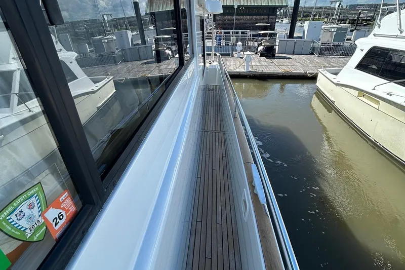 Smooth Yacht Photos Pics 2019 Beneteau Swift Trawler 50 docked, showcasing sleek deck and marina view.