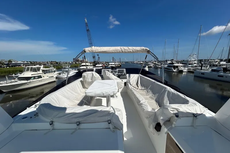 Smooth Yacht Photos Pics 2019 Beneteau Swift Trawler 50 docked, featuring spacious deck seating under a clear blue sky.