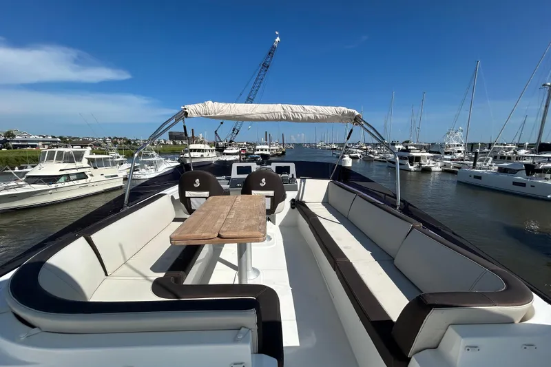Smooth Yacht Photos Pics 2019 Beneteau Swift Trawler 50, spacious deck with seating, docked in a marina.