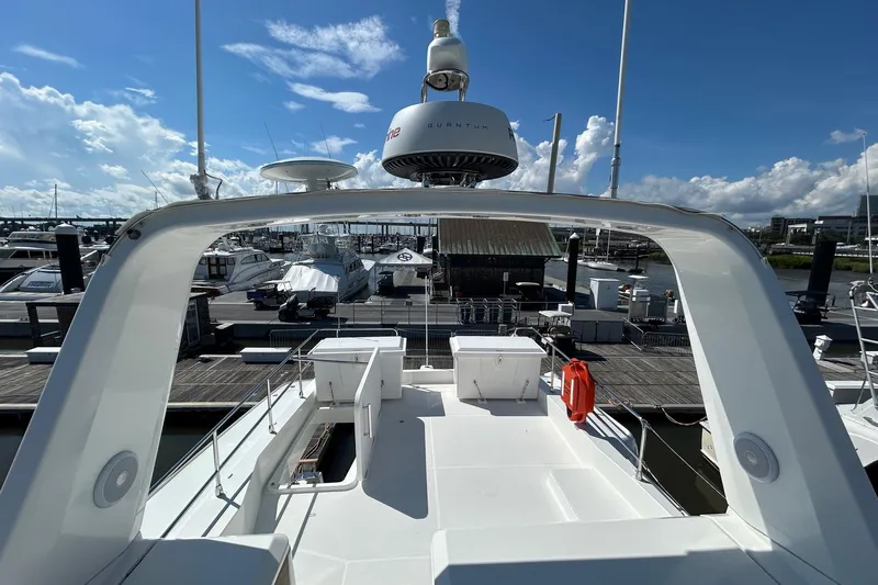 Smooth Yacht Photos Pics 2019 Beneteau Swift Trawler 50 docked at marina under clear blue sky.
