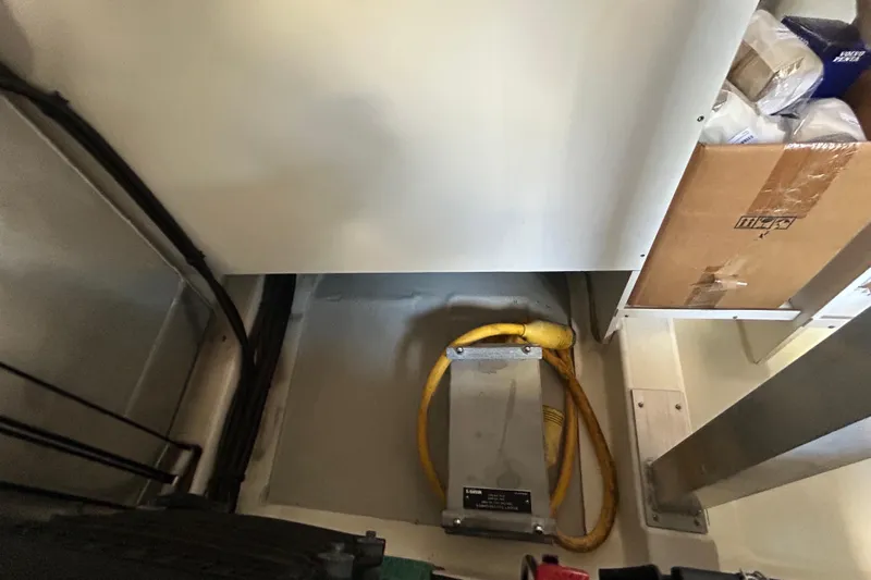 Smooth Yacht Photos Pics Engine room of 2019 Beneteau Swift Trawler 50 with cables and storage.