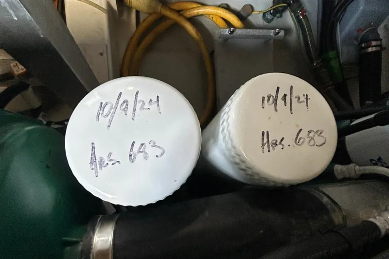 Smooth Yacht Photos Pics Engine room of 2019 Beneteau Swift Trawler 50 with labeled filters, hours noted.