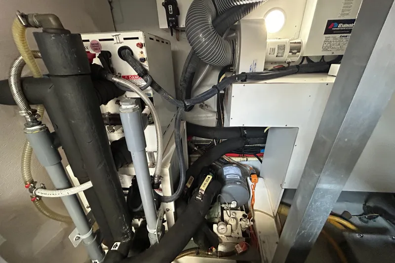 Smooth Yacht Photos Pics Engine room of 2019 Beneteau Swift Trawler 50, showcasing complex mechanical systems and components.