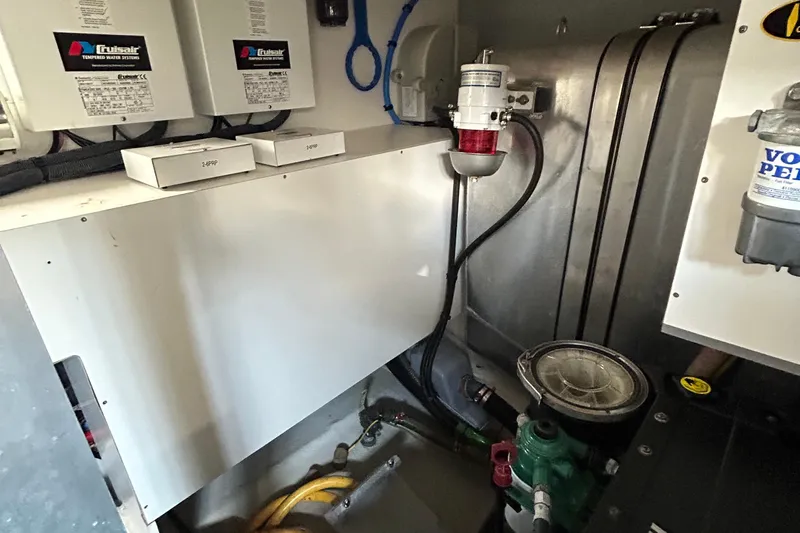 Smooth Yacht Photos Pics Engine room of 2019 Beneteau Swift Trawler 50 with mechanical components and wiring.