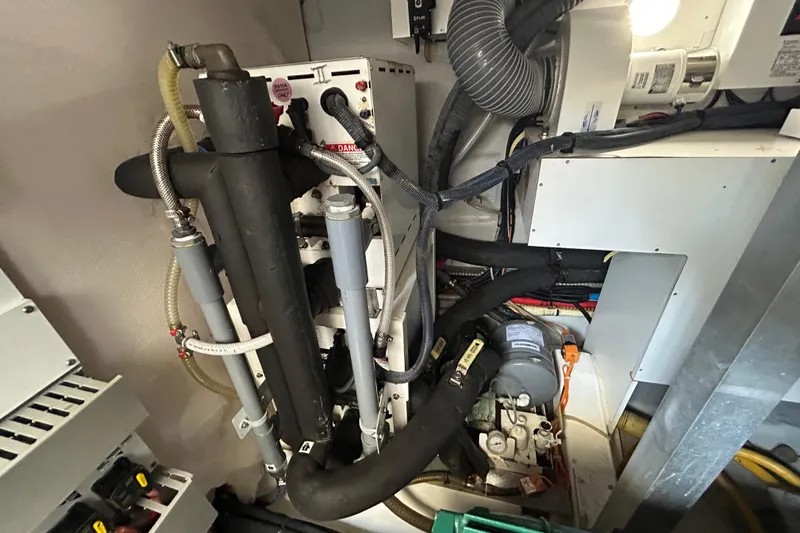 Smooth Yacht Photos Pics Engine room of 2019 Beneteau Swift Trawler 50 with mechanical components and wiring.