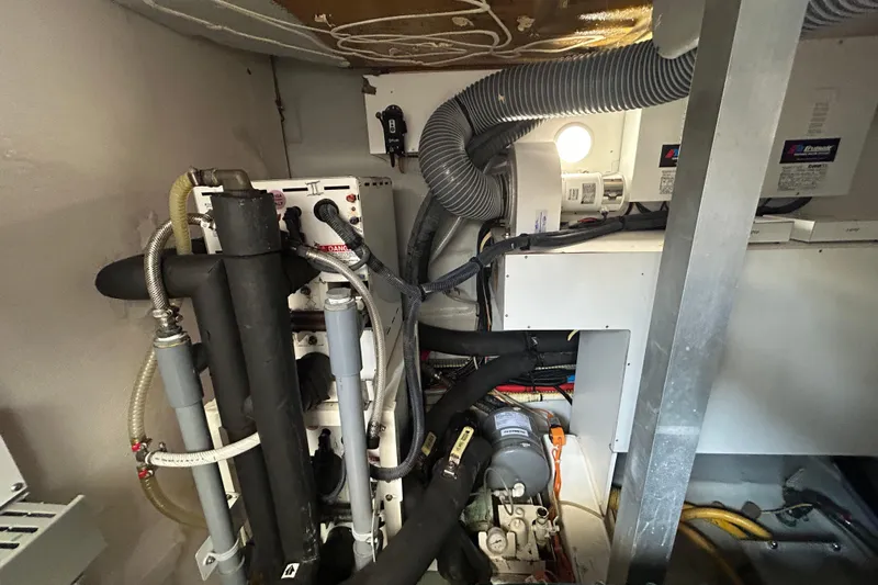 Smooth Yacht Photos Pics Engine room of 2019 Beneteau Swift Trawler 50 with mechanical components and wiring.