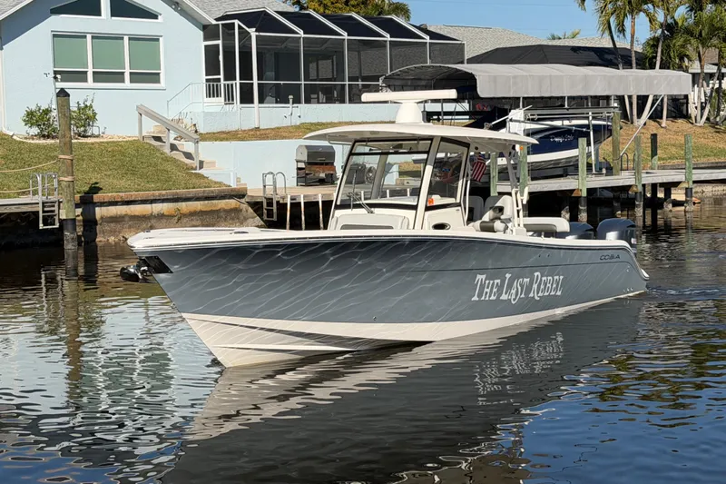  Yacht Photos Pics 2016 Cobia 344 Center Console boat docked near waterfront homes.