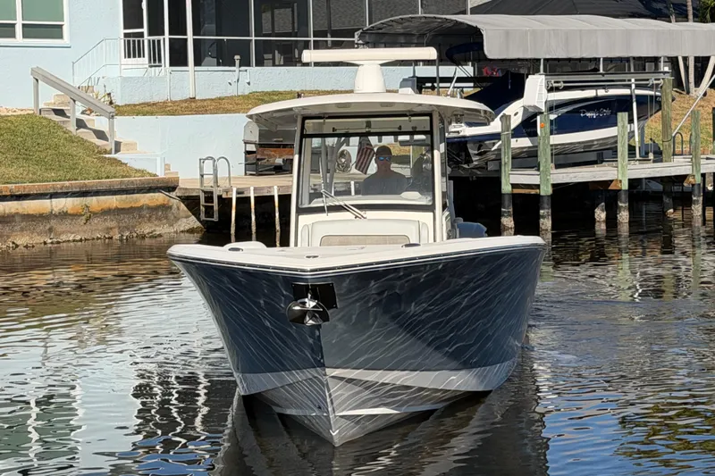  Yacht Photos Pics 2016 Cobia 344 Center Console boat docked near waterfront home.