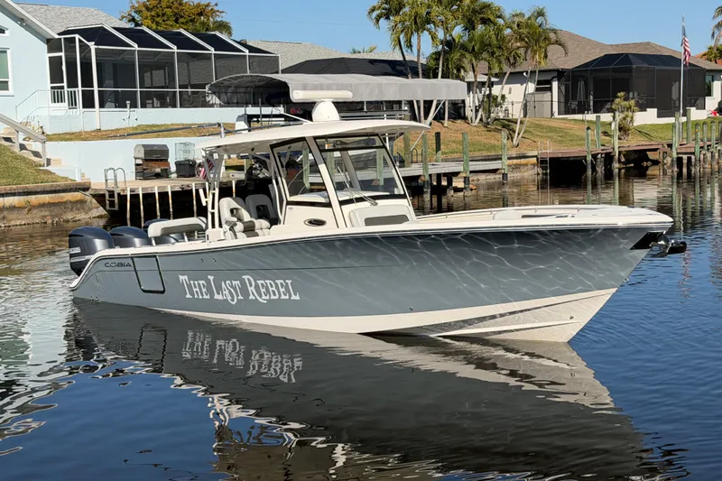  Yacht Photos Pics 2016 Cobia 344 Center Console boat docked in a residential canal.