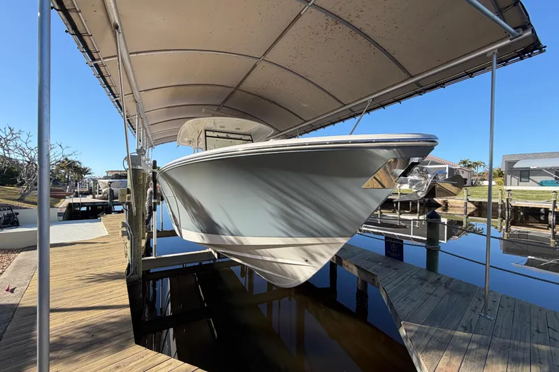  Yacht Photos Pics 2016 Cobia 344 Center Console boat docked under a canopy.