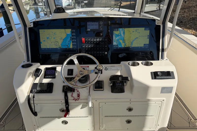  Yacht Photos Pics 2016 Cobia 344 Center Console helm with dual navigation screens and steering wheel.