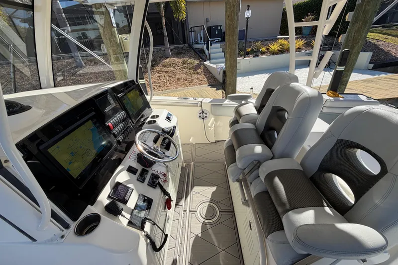  Yacht Photos Pics 2016 Cobia 344 Center Console boat interior with modern navigation system and comfortable seating.
