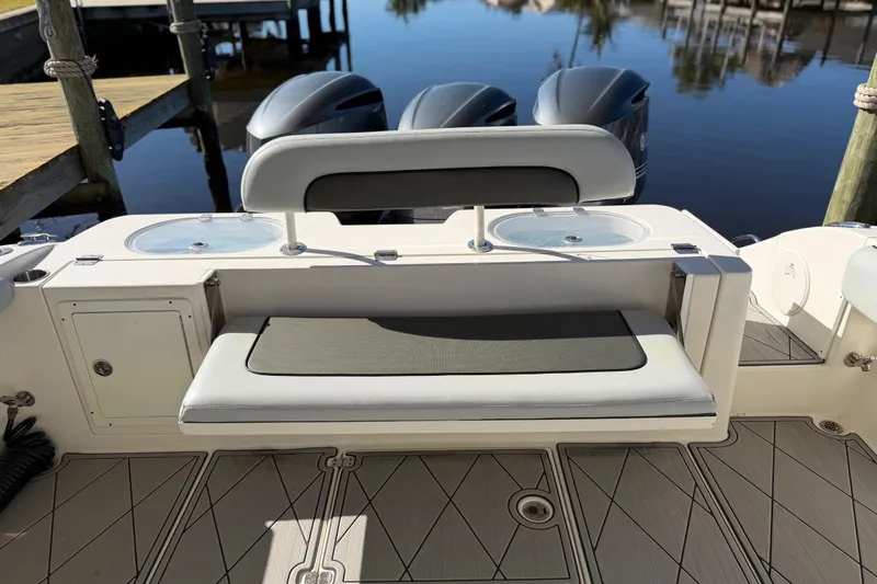  Yacht Photos Pics 2016 Cobia 344 Center Console boat with seating and twin engines at dock.