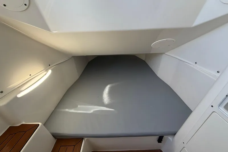  Yacht Photos Pics 2016 Cobia 344 Center Console cabin interior with cushioned sleeping area.