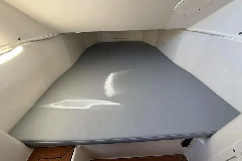  Yacht Photos Pics 2016 Cobia 344 Center Console cabin interior with cushioned sleeping area.