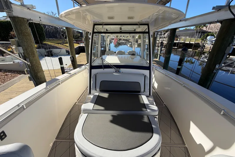  Yacht Photos Pics 2016 Cobia 344 Center Console boat interior at dock, showcasing seating and helm.