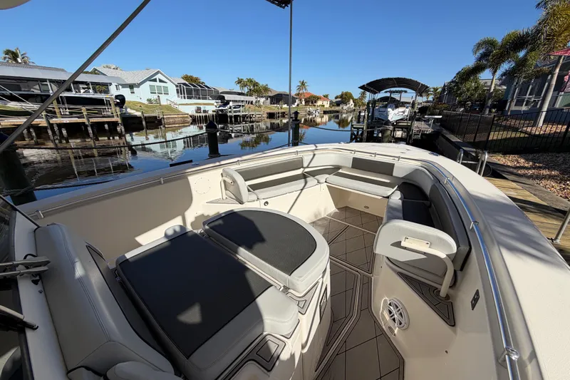  Yacht Photos Pics 2016 Cobia 344 Center Console boat docked in a scenic residential canal.