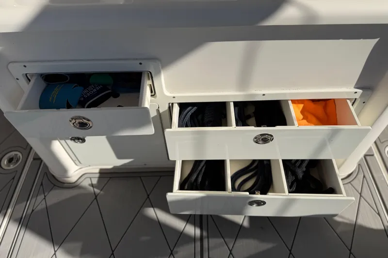  Yacht Photos Pics Storage compartments on a 2016 Cobia 344 Center Console boat, containing ropes and accessories.