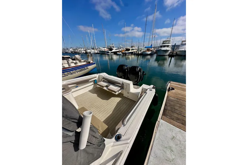 Seahorse Yacht Photos Pics 2018 Wellcraft 290 Coastal boat docked in a marina with clear blue skies.