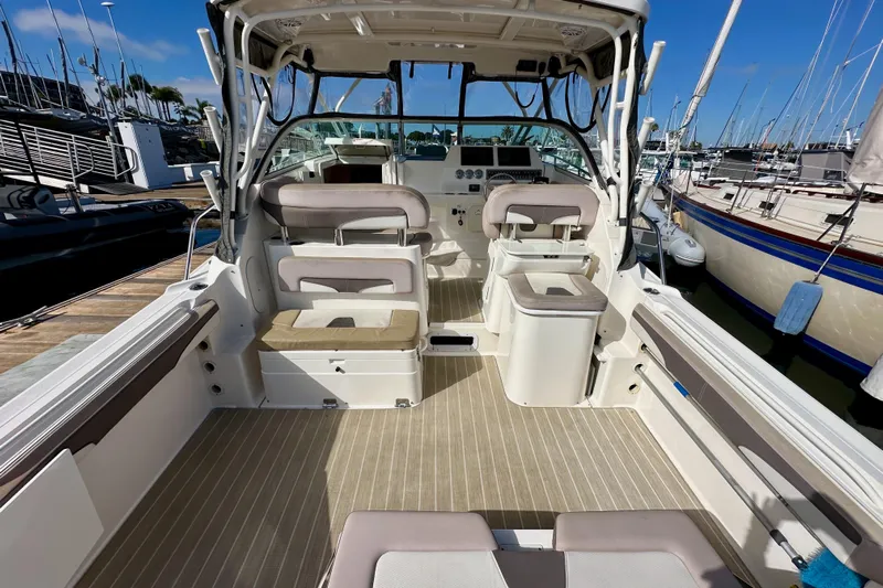 Seahorse Yacht Photos Pics 2018 Wellcraft 290 Coastal boat interior with seating and helm, docked at marina.