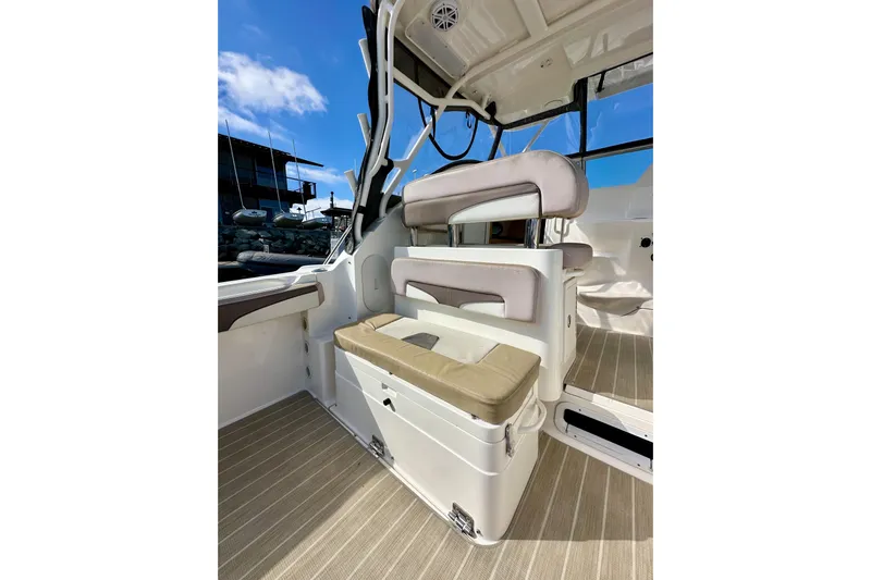 Seahorse Yacht Photos Pics 2018 Wellcraft 290 Coastal boat interior with cushioned seating and clear blue sky.