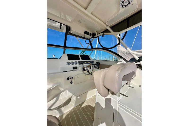 Seahorse Yacht Photos Pics 2018 Wellcraft 290 Coastal boat cockpit with steering wheel and navigation instruments.