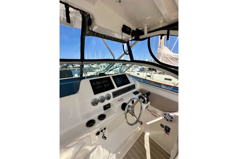 Seahorse Yacht Photos Pics Helm of 2018 Wellcraft 290 Coastal boat with modern controls and marina view.