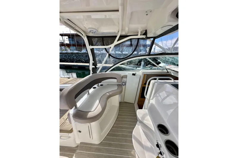 Seahorse Yacht Photos Pics 2018 Wellcraft 290 Coastal boat interior with seating and helm, docked at marina.