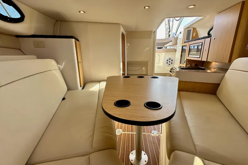 Seahorse Yacht Photos Pics Interior of 2018 Wellcraft 290 Coastal boat with seating and kitchenette.