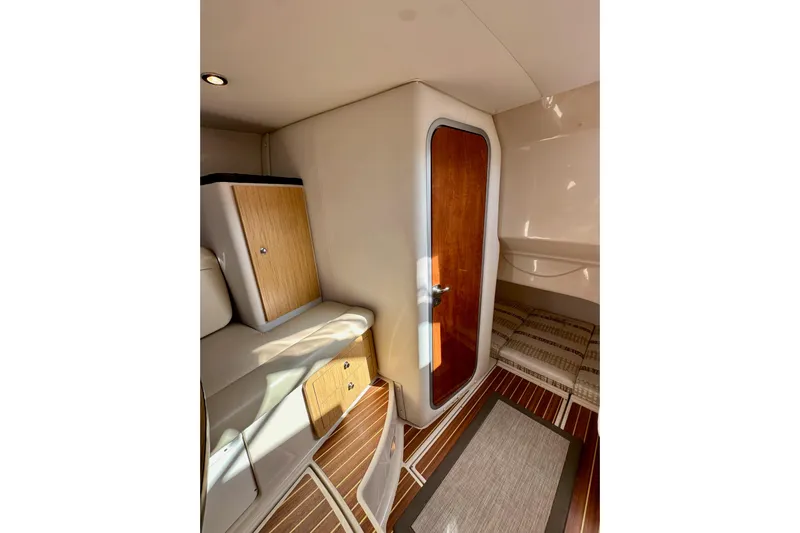 Seahorse Yacht Photos Pics 2018 Wellcraft 290 Coastal cabin interior with wood accents and seating area.