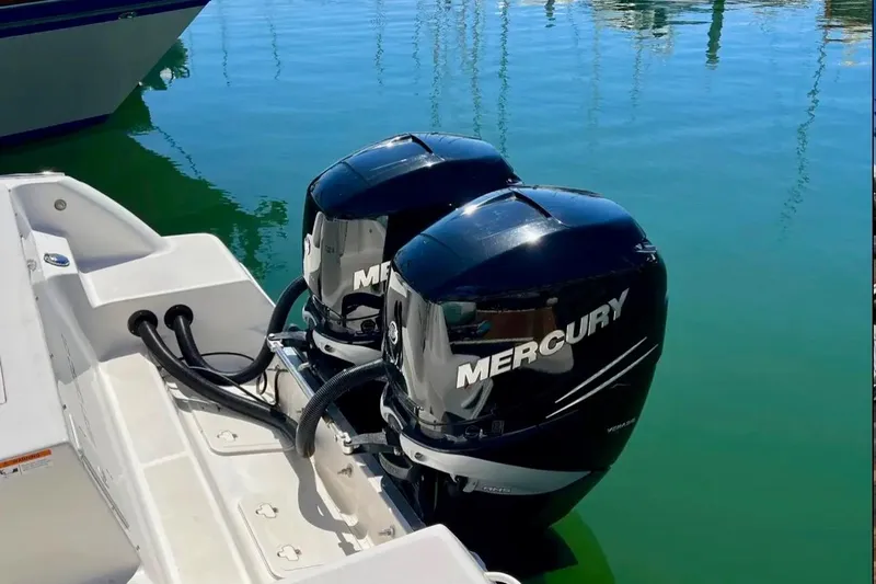 Seahorse Yacht Photos Pics 2018 Wellcraft 290 Coastal boat with twin Mercury outboard engines on calm water.