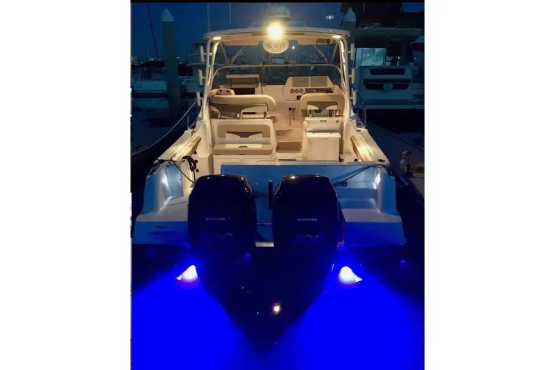 Seahorse Yacht Photos Pics 2018 Wellcraft 290 Coastal boat with illuminated blue underwater lights at night.