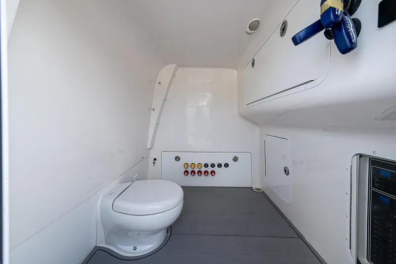 Hoosier Hooker Yacht Photos Pics Interior of 2021 Invincible 40 Catamaran bathroom with modern fixtures and control panel.