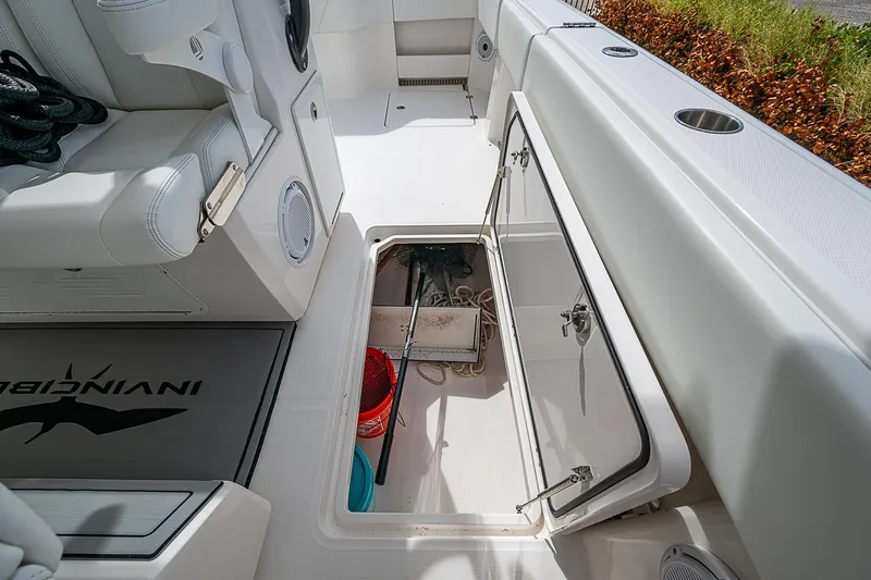 Hoosier Hooker Yacht Photos Pics 2021 Invincible 40 Catamaran storage compartment with cleaning supplies and equipment.